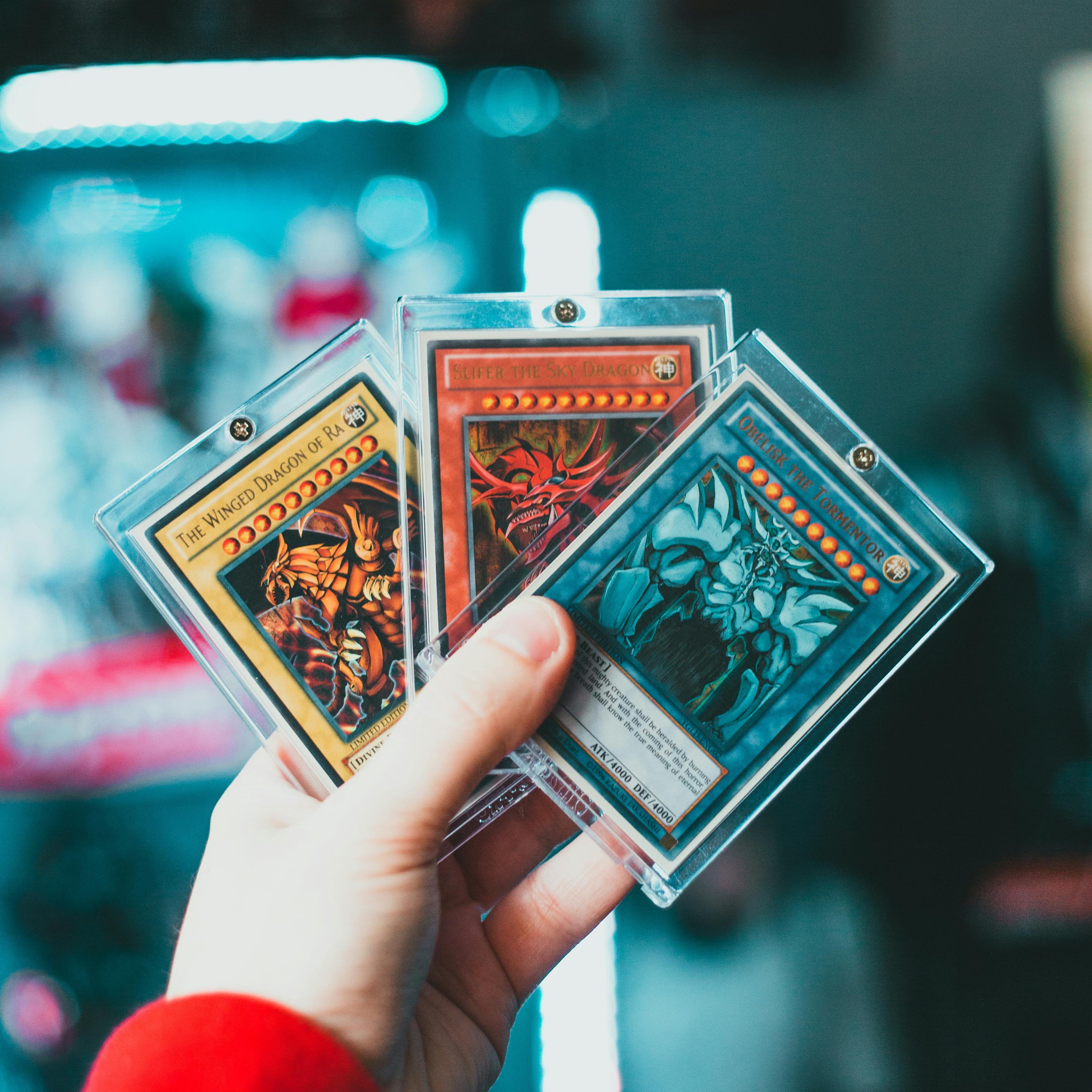 Trading card collection featuring Pokémon TCG, Yu-Gi-Oh!, and sports cards — sealed booster packs and single cards from multiple sets